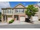 Charming townhome with a brick facade, attached garage, and well-maintained landscaping at 3203 Cyrus Point Nw Ln, Kennesaw, GA 30152