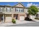 Two-story brick townhome with attached garage and manicured front yard at 3203 Cyrus Point Nw Ln, Kennesaw, GA 30152