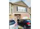 Charming townhome featuring a brick facade, neutral siding, and a welcoming front door with a decorative wreath at 3203 Cyrus Point Nw Ln, Kennesaw, GA 30152