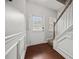 Hallway with a white door and trim with hardwood floors and stairs at 3203 Cyrus Point Nw Ln, Kennesaw, GA 30152