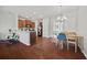 Open kitchen and dining area with stainless steel appliances, breakfast bar, and hardwood floors at 3203 Cyrus Point Nw Ln, Kennesaw, GA 30152
