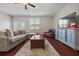 Comfortable living room with large sectional sofa and hardwood floors at 3203 Cyrus Point Nw Ln, Kennesaw, GA 30152