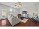 Bright living room with hardwood floors, a comfortable sofa, and natural light at 3203 Cyrus Point Nw Ln, Kennesaw, GA 30152