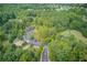 Aerial view of the neighborhood showing wooded areas, streets, and green spaces at 4236 Tacoma Trce, Suwanee, GA 30024