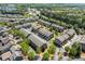 Wide aerial view of a residential area featuring well-maintained townhomes with green landscaping and tree-lined streets at 4236 Tacoma Trce, Suwanee, GA 30024