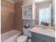 Well-maintained bathroom features tile flooring, and vanity sink, with an adjacent bedroom at 4236 Tacoma Trce, Suwanee, GA 30024