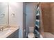 Bright bathroom featuring a tub with tiled walls, a toilet, and a single sink vanity with a countertop at 4236 Tacoma Trce, Suwanee, GA 30024