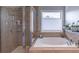 Relaxing bathroom features a separate shower and soaking tub, perfect for unwinding after a long day at 4236 Tacoma Trce, Suwanee, GA 30024