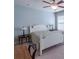 Comfortable bedroom features a ceiling fan and a large window letting in natural light at 4236 Tacoma Trce, Suwanee, GA 30024