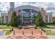 Exterior of Suwanee City Hall, showcasing its grand architecture and American and Georgia flags at 4236 Tacoma Trce, Suwanee, GA 30024