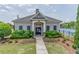 Exterior view of community clubhouse and pool, featuring well-manicured landscaping and an inviting entrance at 4236 Tacoma Trce, Suwanee, GA 30024