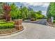 A gated entrance with brick pillars and manicured landscaping provides security to the community at 4236 Tacoma Trce, Suwanee, GA 30024