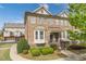 Beautiful brick townhome with manicured landscaping and inviting entrance at 4236 Tacoma Trce, Suwanee, GA 30024