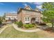 Charming brick townhome featuring a well-maintained lawn and garden at 4236 Tacoma Trce, Suwanee, GA 30024