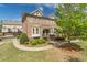 Brick townhome with a well-kept lawn and mature tree in the front yard at 4236 Tacoma Trce, Suwanee, GA 30024