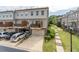 Townhome exterior featuring attached garages, a private deck, and manicured landscaping at 4236 Tacoma Trce, Suwanee, GA 30024