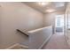 Bright hallway with carpet flooring leads to bedroom, providing a seamless transition throughout the home at 4236 Tacoma Trce, Suwanee, GA 30024