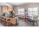 A well-lit kitchen area featuring granite countertops, stainless appliances and a dining table at 4236 Tacoma Trce, Suwanee, GA 30024