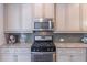 Gourmet kitchen showcasing stainless steel appliances, gas range, and ample counter space at 4236 Tacoma Trce, Suwanee, GA 30024