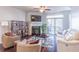 Comfortable living room with a fireplace, TV, ceiling fan, and sliding glass doors at 4236 Tacoma Trce, Suwanee, GA 30024
