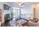 Inviting living room featuring a cozy fireplace, TV, sofa, and sliding glass doors at 4236 Tacoma Trce, Suwanee, GA 30024