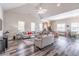 Stylish living room featuring modern decor, gray walls, wood floors, and comfortable furnishings at 4236 Tacoma Trce, Suwanee, GA 30024