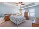 Comfortable main bedroom features a tray ceiling with fan and soft blue walls, creating a peaceful retreat at 4236 Tacoma Trce, Suwanee, GA 30024