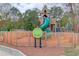 Fenced community playground with climbing structures and slides near walking path at 4236 Tacoma Trce, Suwanee, GA 30024