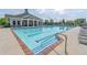 View of a large swimming pool with lounge chairs and a community building at 4236 Tacoma Trce, Suwanee, GA 30024