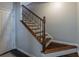 Elegant staircase features decorative iron railings, wooden treads, and a white trim at 4236 Tacoma Trce, Suwanee, GA 30024