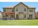 Home's backyard featuring a large grassy area and a patio with a pergola at 6565 Bentley Ridge Dr, Cumming, GA 30040