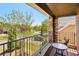 Relaxing balcony with stone accents, a small table, and scenic views of the surrounding neighborhood at 6565 Bentley Ridge Dr, Cumming, GA 30040