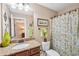 Bathroom featuring granite vanity, toilet and shower with patterned curtain at 6565 Bentley Ridge Dr, Cumming, GA 30040