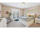 Bedroom with a white bed, grey chair and direct access to a private balcony at 6565 Bentley Ridge Dr, Cumming, GA 30040