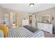 Inviting bedroom with natural light, neutral colors and classic furnishings at 6565 Bentley Ridge Dr, Cumming, GA 30040