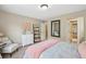 Bright bedroom featuring a cozy chair, white dresser, decorative ladder, and a comfortable bed at 6565 Bentley Ridge Dr, Cumming, GA 30040