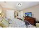 Bedroom featuring a bed, dresser with television, and a view of the outdoors at 6565 Bentley Ridge Dr, Cumming, GA 30040