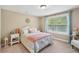 Bright bedroom with natural light, window view, and comfortable furnishings at 6565 Bentley Ridge Dr, Cumming, GA 30040