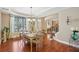 Dining room with natural light, hardwood floors, elegant decor, and staircase view at 6565 Bentley Ridge Dr, Cumming, GA 30040