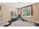 Well-lit exercise room with carpet, mirror, elliptical, weights and rowing machine at 6565 Bentley Ridge Dr, Cumming, GA 30040
