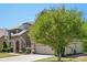 Elegant home exterior featuring a well-maintained lawn and a spacious two-car garage at 6565 Bentley Ridge Dr, Cumming, GA 30040