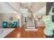 Bright foyer featuring hardwood floors, a staircase, and elegant decor at 6565 Bentley Ridge Dr, Cumming, GA 30040