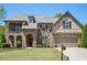 Charming brick and stone home with a well-manicured lawn and inviting front entrance at 6565 Bentley Ridge Dr, Cumming, GA 30040
