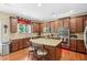 Gourmet kitchen with island, granite countertops, stainless steel appliances, and ample cabinetry at 6565 Bentley Ridge Dr, Cumming, GA 30040