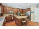 Well-equipped kitchen with hardwood floors, island with bar seating, and stainless steel appliances at 6565 Bentley Ridge Dr, Cumming, GA 30040
