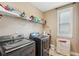 Well-equipped laundry room with Samsung washer and dryer and overhead storage shelf at 6565 Bentley Ridge Dr, Cumming, GA 30040