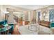 Open-concept living room with hardwood floors, stylish decor, and ample natural light at 6565 Bentley Ridge Dr, Cumming, GA 30040