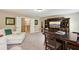 Spacious living room with a large TV, built-in shelves, seating, and a chess set on a wooden table at 6565 Bentley Ridge Dr, Cumming, GA 30040