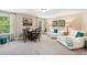 Inviting living room with ample seating, a chess table, natural light, and stylish decor at 6565 Bentley Ridge Dr, Cumming, GA 30040