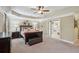Spacious main bedroom features tray ceiling, elegant decor, and ensuite access at 6565 Bentley Ridge Dr, Cumming, GA 30040